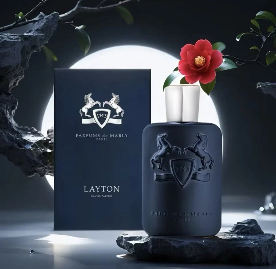 Dark blue perfume bottle with 'Parfums de Marly' packaging and a red flower on a dark background